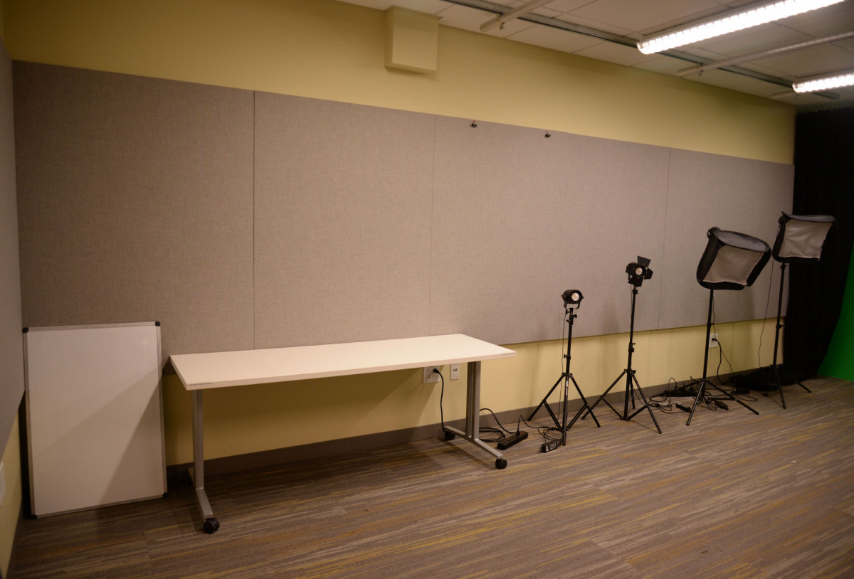 DMC Video and Photography Studio DMC video studio has a white board and a table on casters.