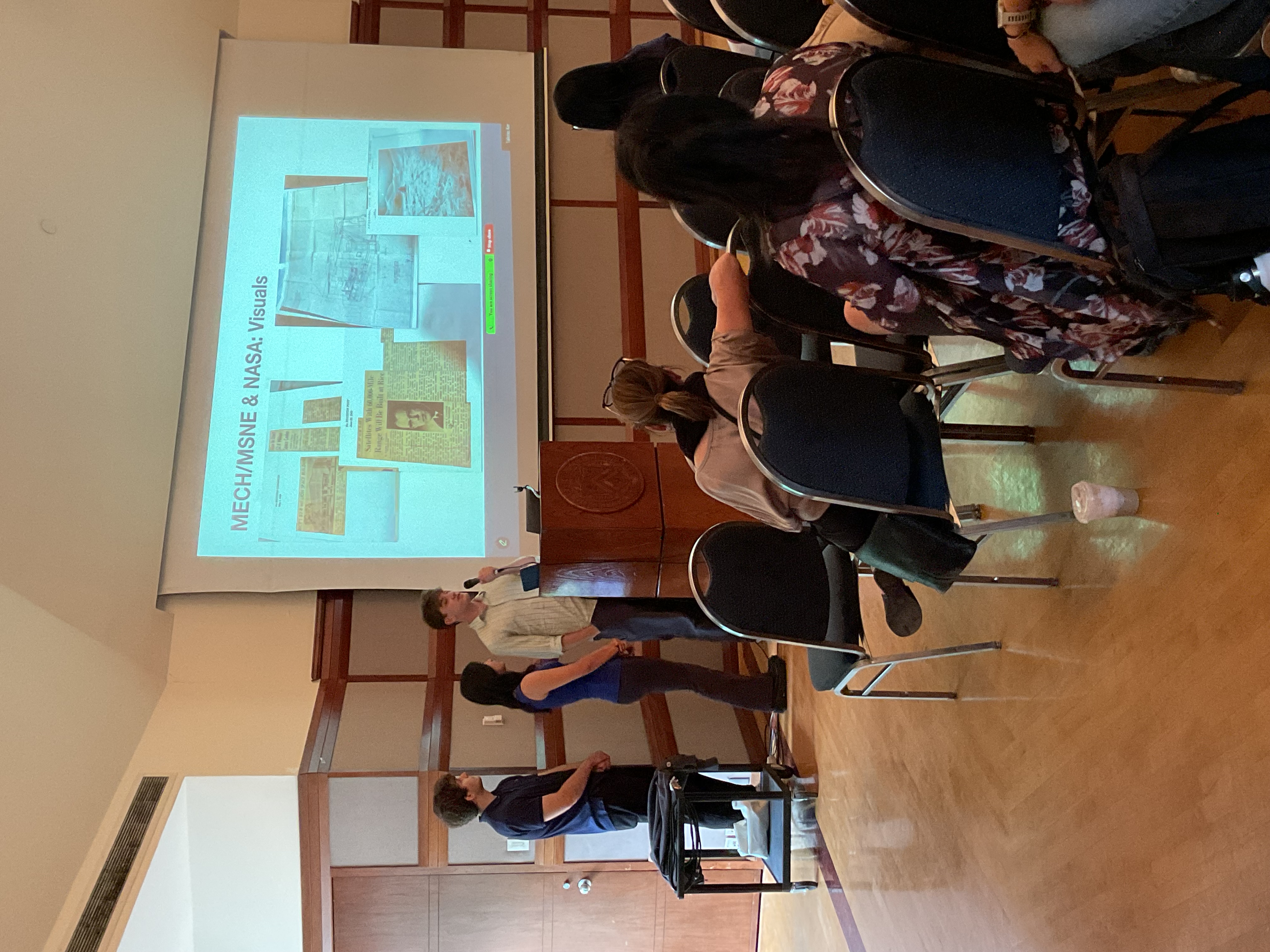 person presenting newspaper clippings