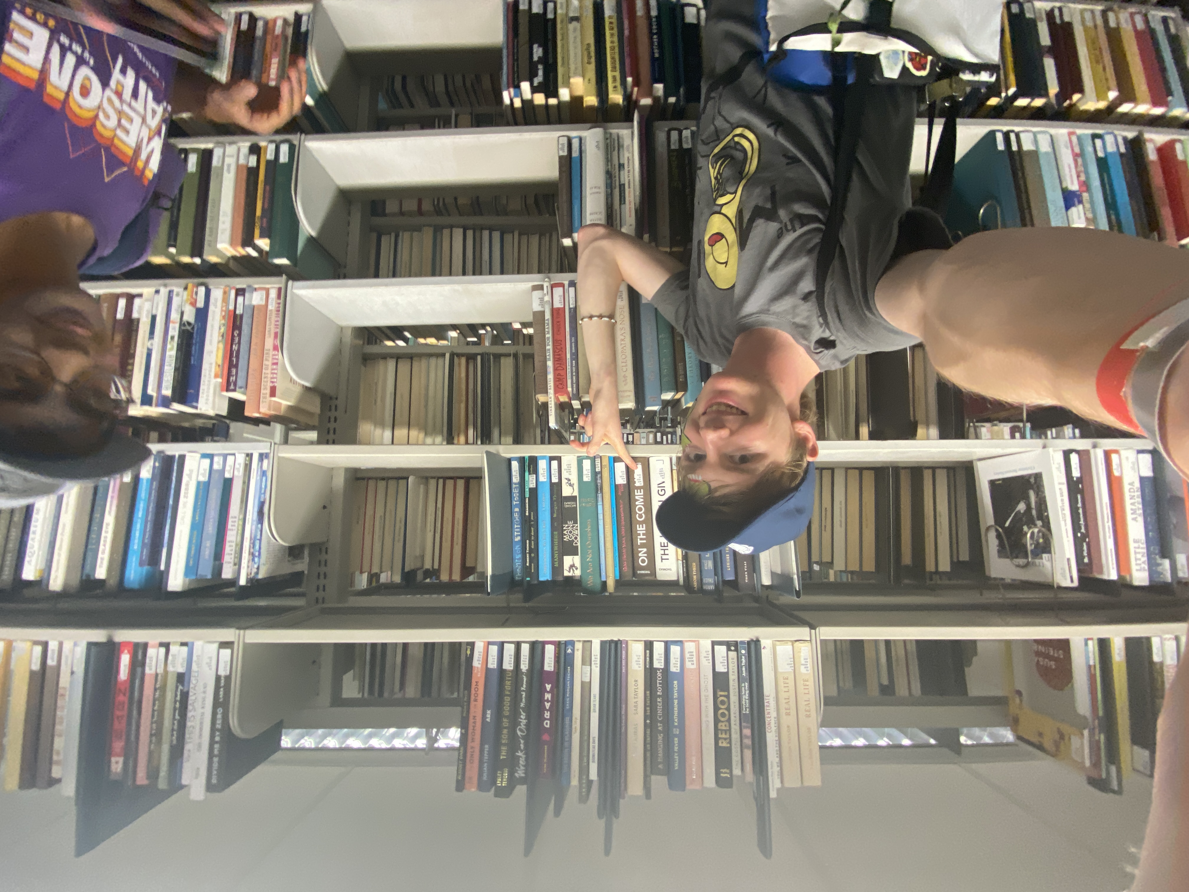 students pointing at books