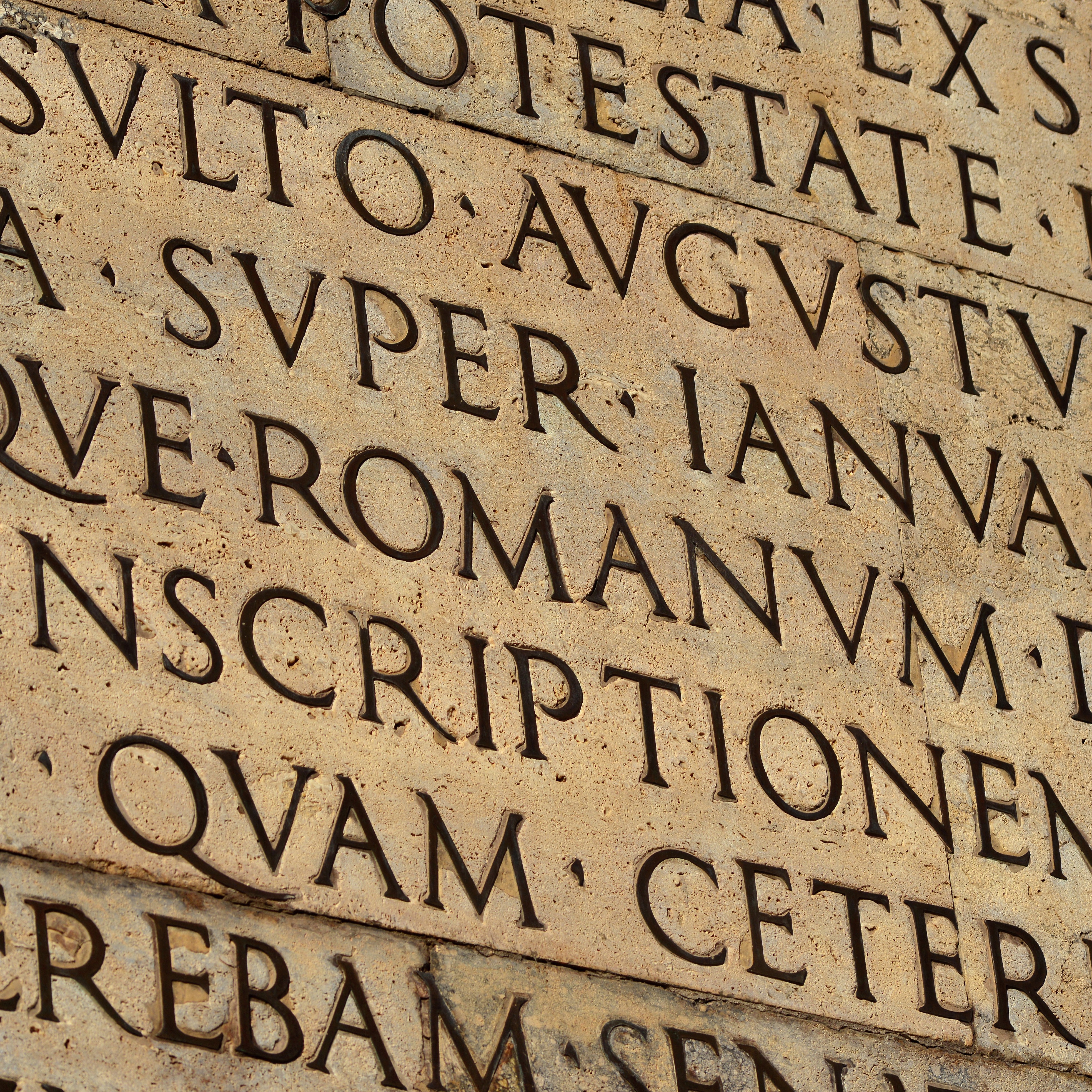 engraved Latin text on a stone wall