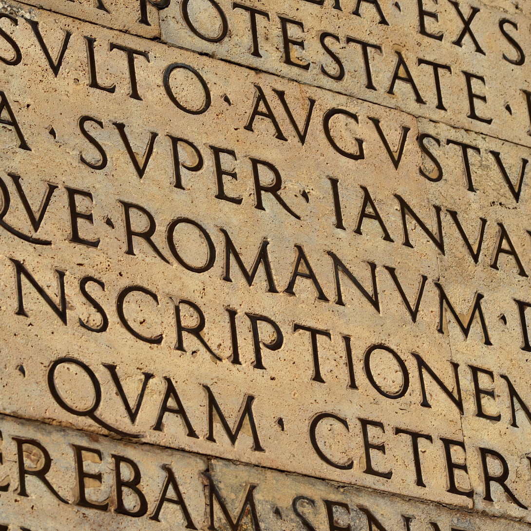 engraved Latin text on a stone wall