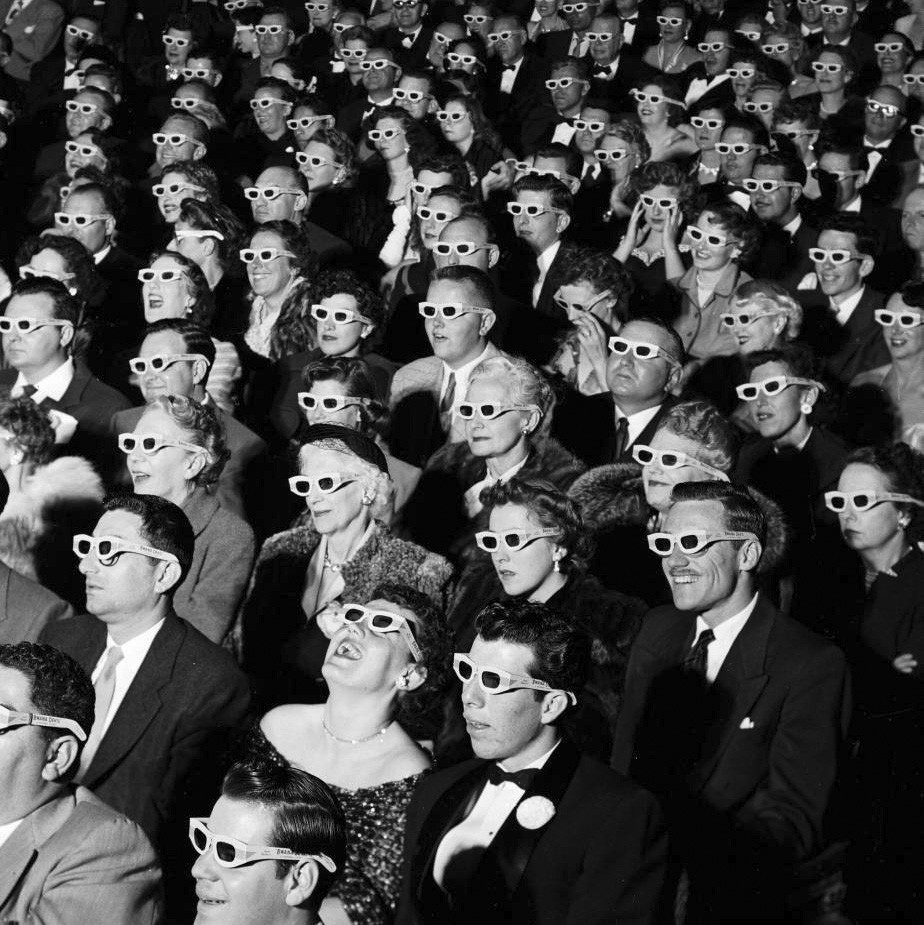 1950s crowd in a theater wearing 3d glasses
